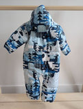 Columbia snowsuit with a blue and white forest graphic design, featuring a hood, displayed on a wooden hanger.