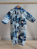 Columbia snowsuit with a blue and white forest graphic design, featuring a hood, displayed on a wooden hanger.